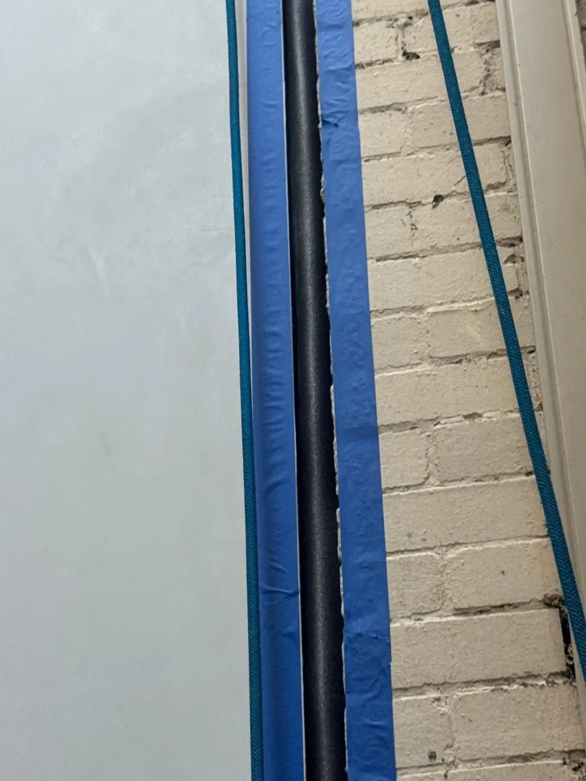 New sealant in a vertical joint between render and brick