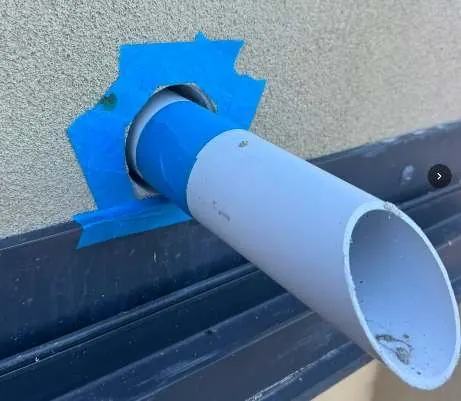 Balcony overflow pipe sealed around its full circumference to stop water getting in behind the render