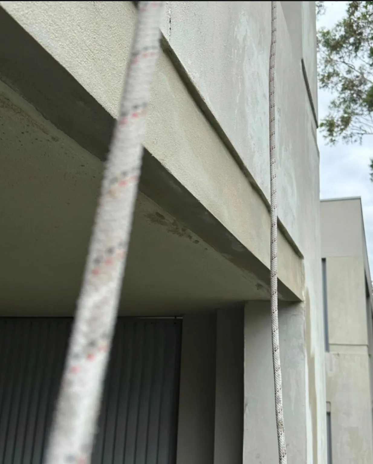 Remedial render repair to a balcony edge, carried out by our rope access technicians